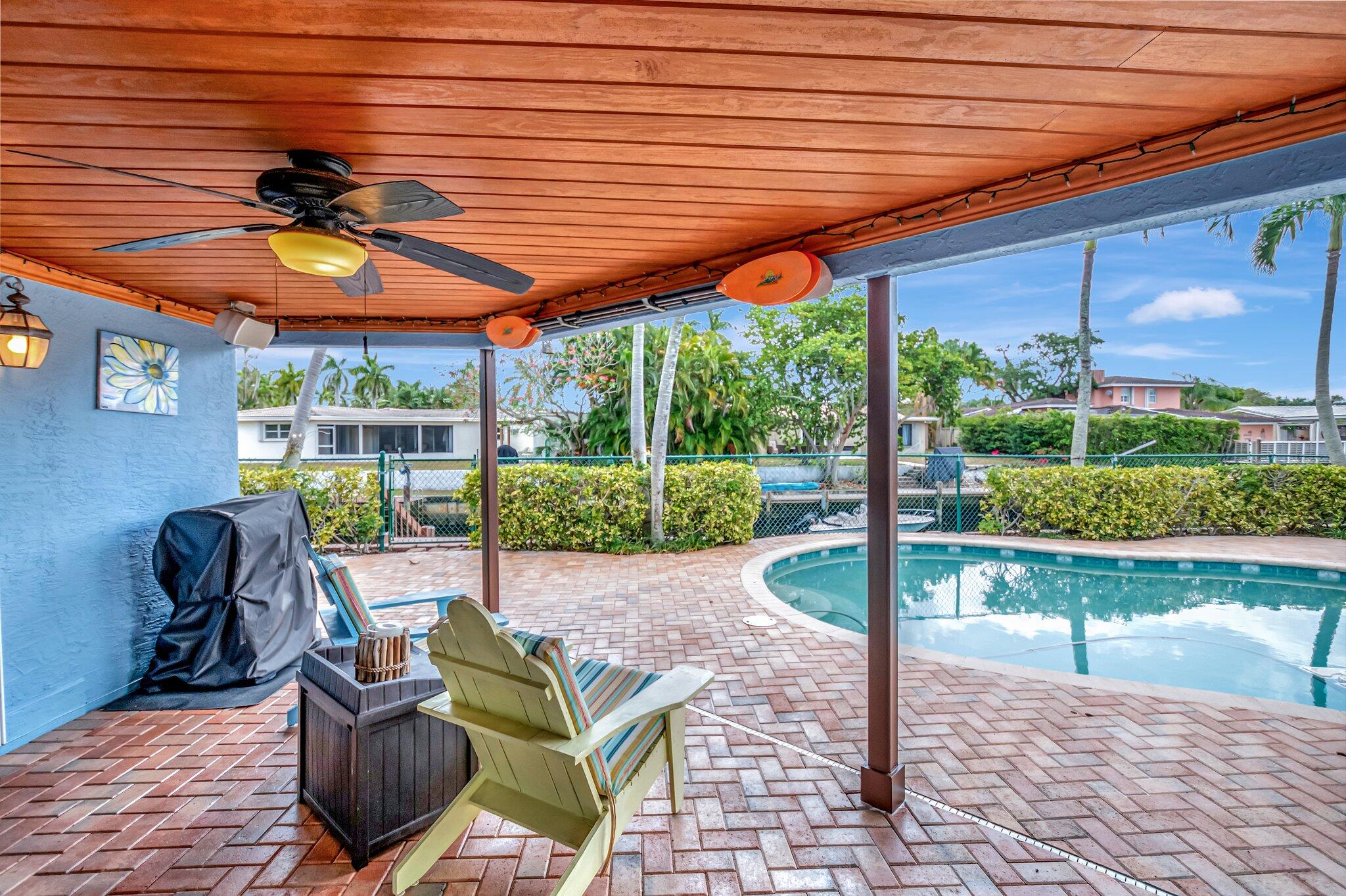 166 Southwest 8th Avenue Boca Raton, FL 33486 - Photo 18 of 25 a porch area with table and chairs