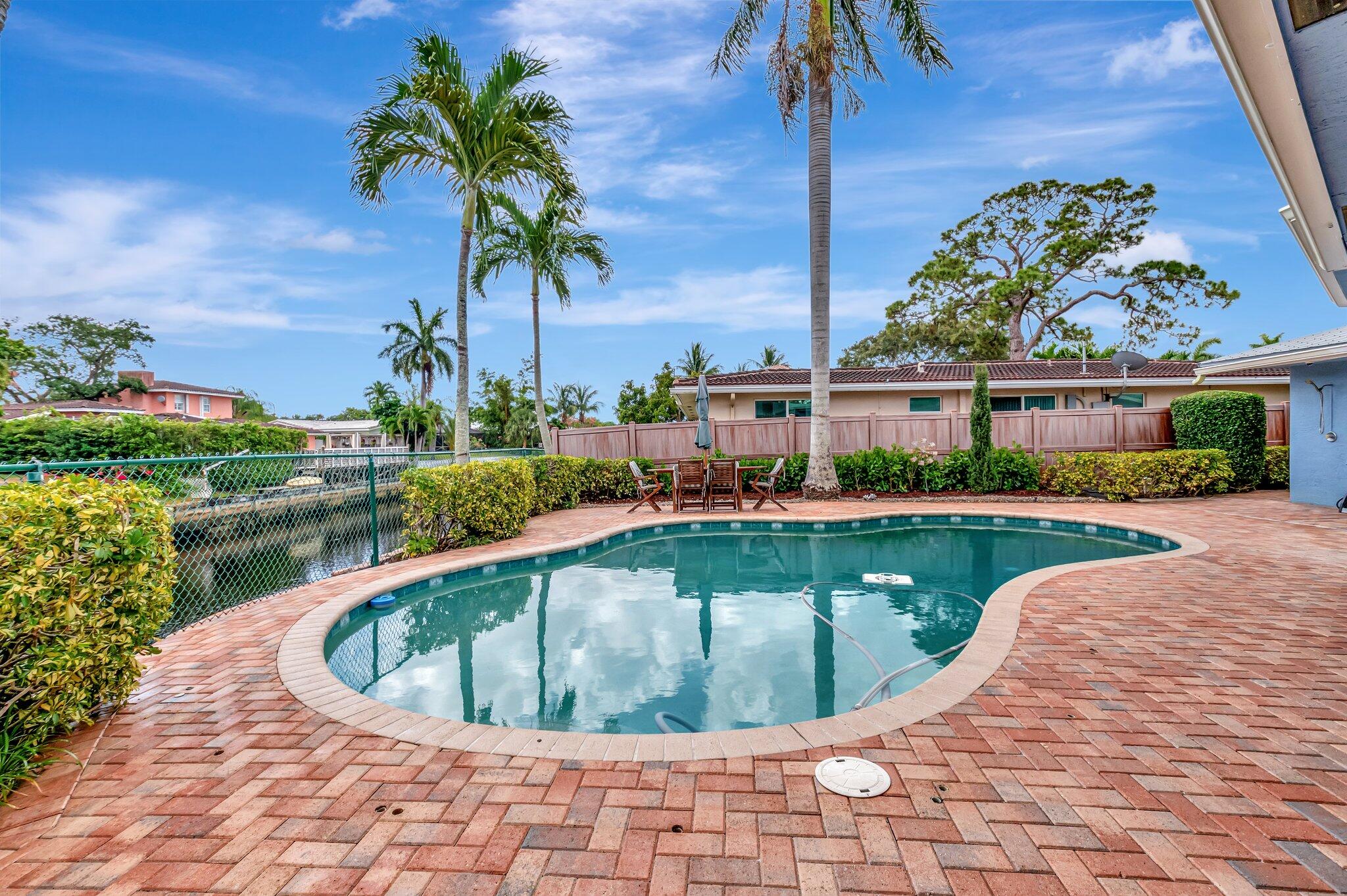 166 Southwest 8th Avenue Boca Raton, FL 33486 - Photo 20 of 25 a view of a swimming pool with a patio