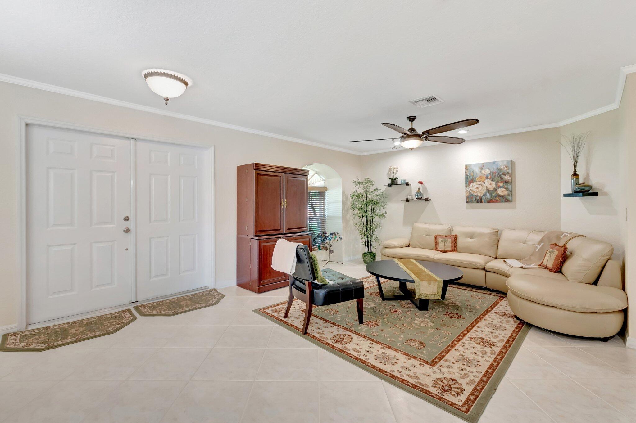 166 Southwest 8th Avenue Boca Raton, FL 33486 - Photo 2 of 25 a living room with furniture and a chandelier