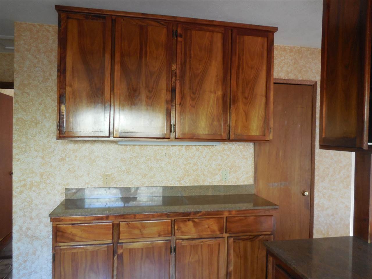 2850 Omaopio Road Kula, HI 96790 - Photo 3 of 20 a sink with wooden cabinets