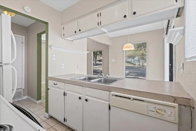 a view with granite countertop a sink and a granite counter tops