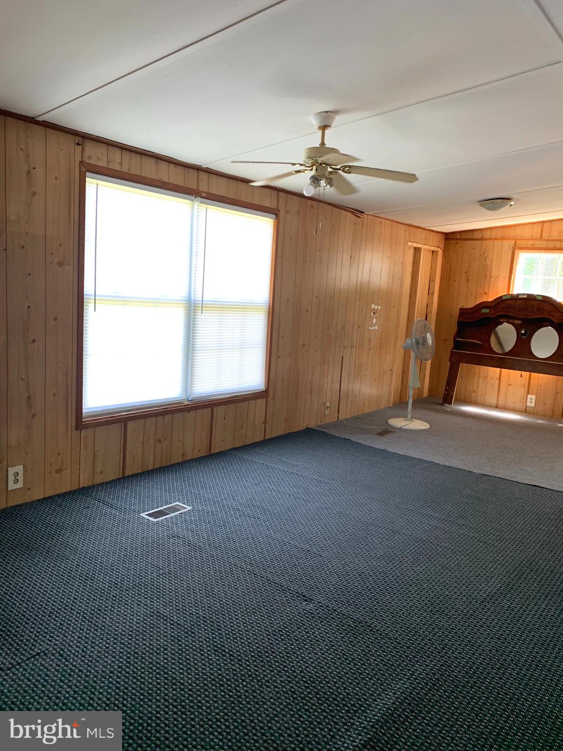 5816 Cornstack Road Marion Station, MD 21838 - Photo 5 of 9 an empty room with windows and fan