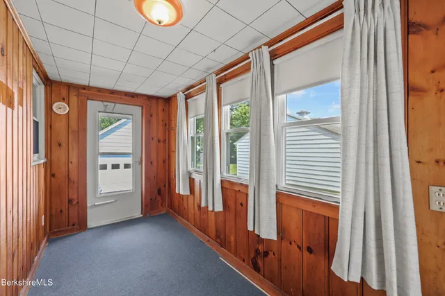 a view of a bathroom with wooden floor and windows