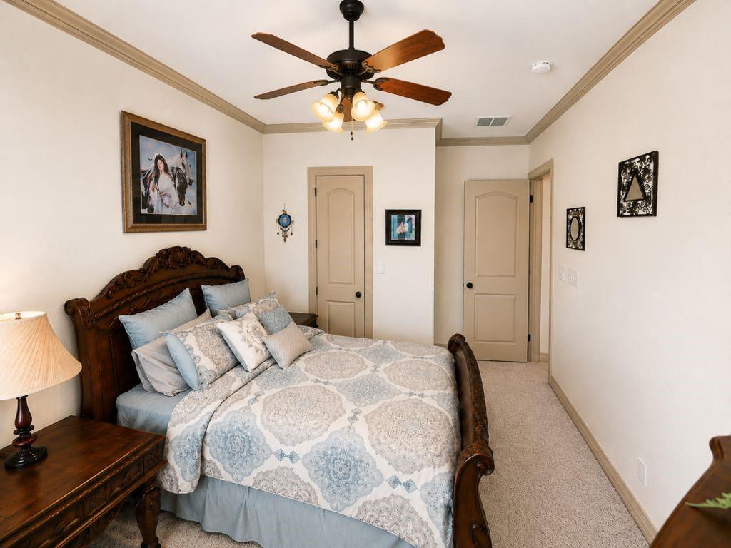 7005 Peter's Path Colleyville, TX 76034 - Photo 27 of 40 a bedroom with a bed and a chandelier