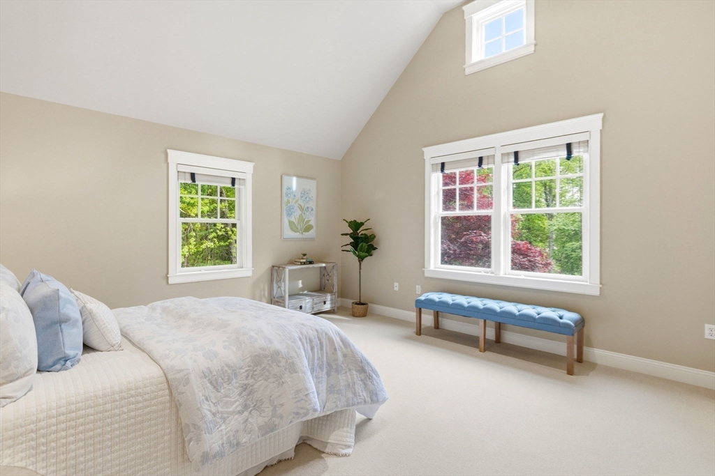 244 Musterfield Road Concord, MA 01742 - Photo 27 of 42 a spacious bedroom with a bed and a window