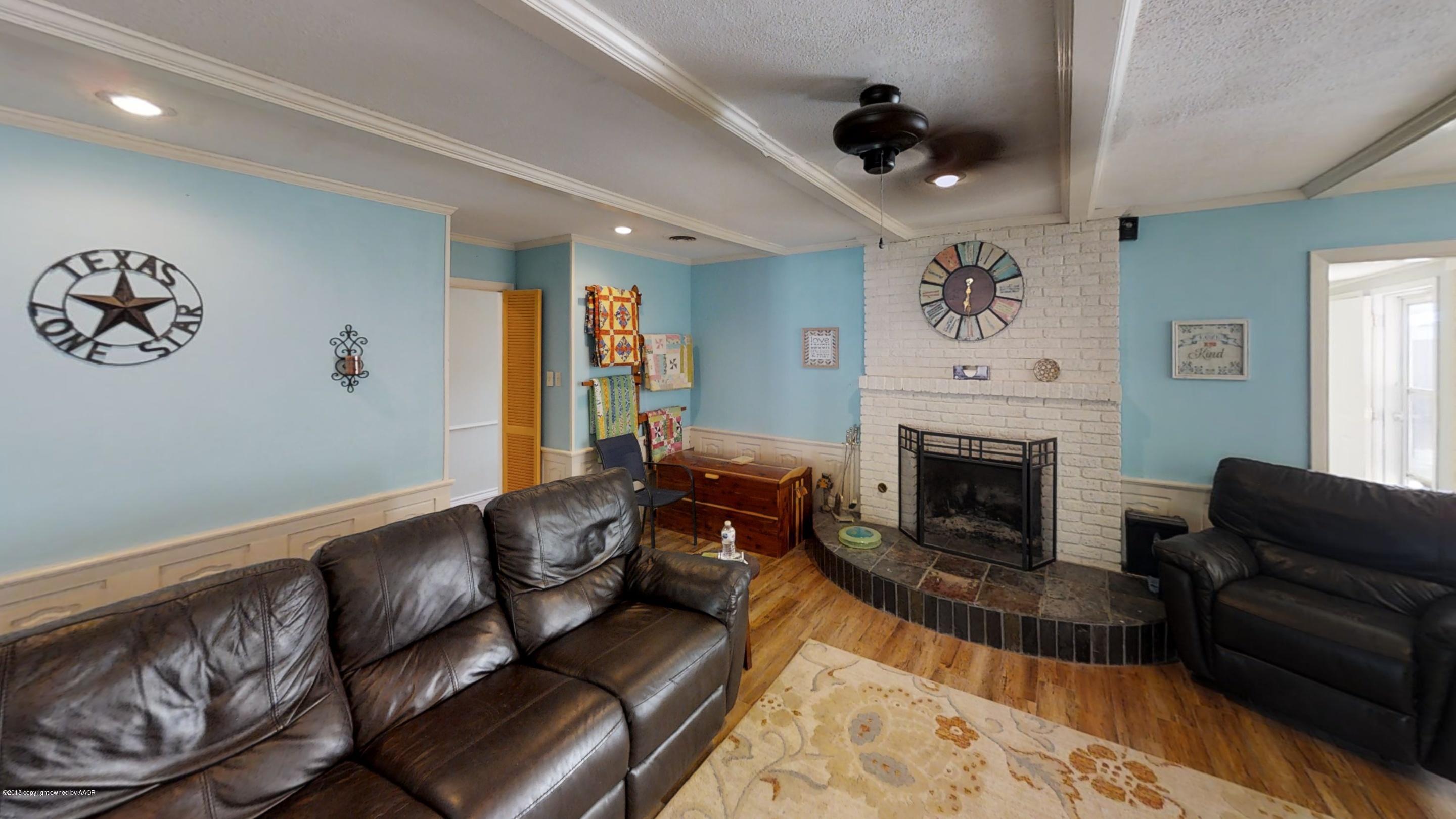 3308 Bedford Road Amarillo, TX 79106 - Photo 11 of 31 a living room with furniture and a fireplace