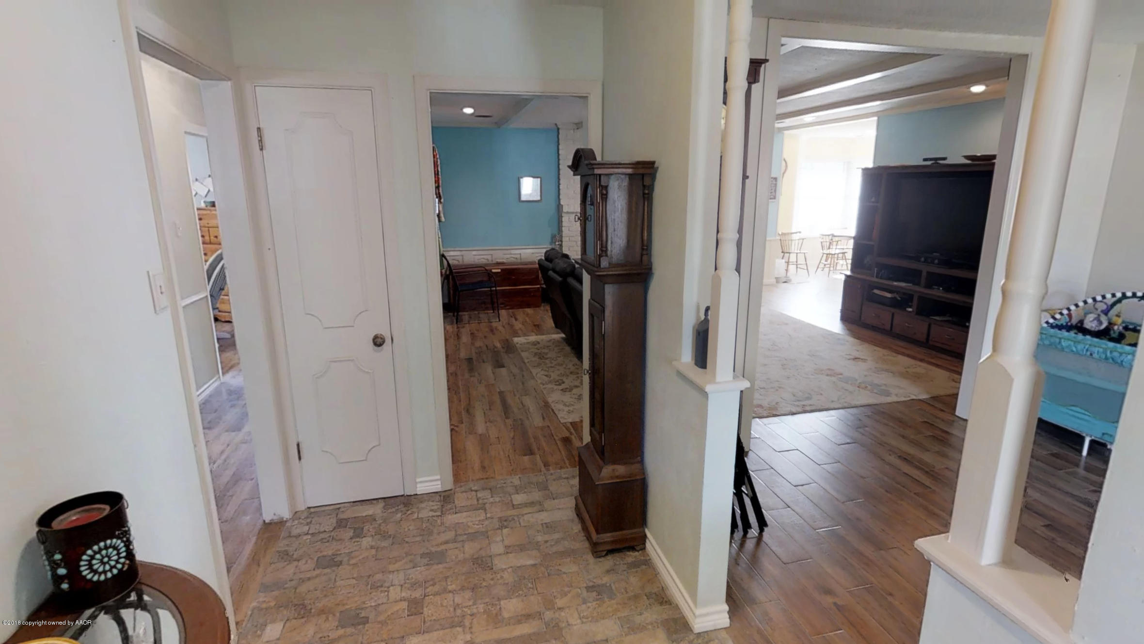 3308 Bedford Road Amarillo, TX 79106 - Photo 16 of 31 a view of a hallway with wooden floor and furniture
