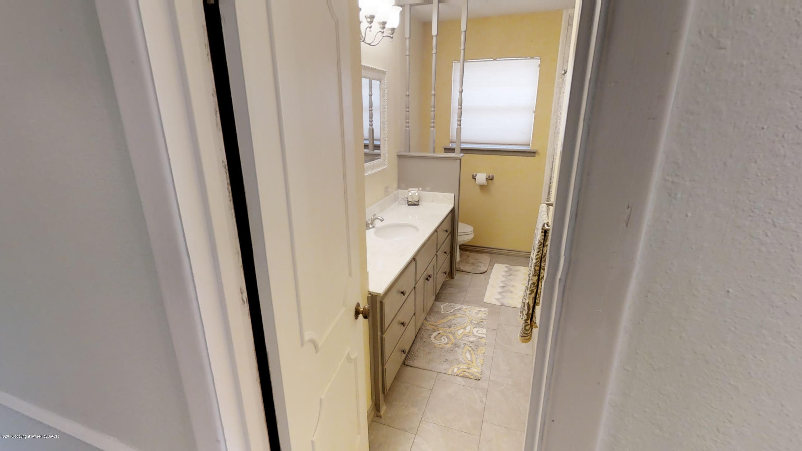 3308 Bedford Road Amarillo, TX 79106 - Photo 19 of 31 a bathroom with a tub and a glass door