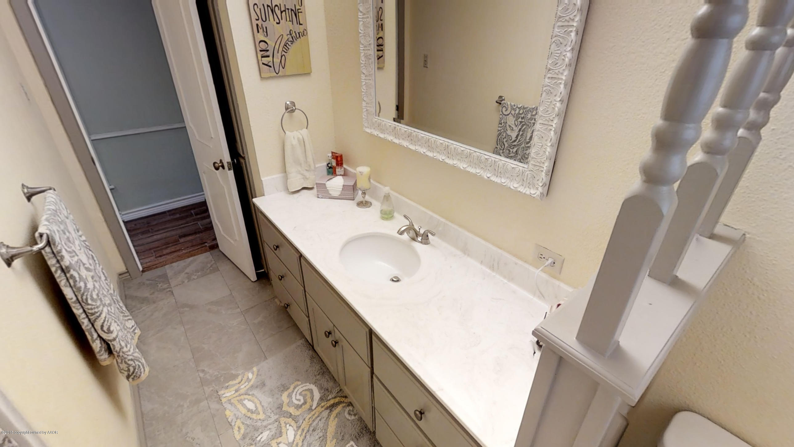 3308 Bedford Road Amarillo, TX 79106 - Photo 20 of 31 a bathroom with a bathtub sink and a mirror