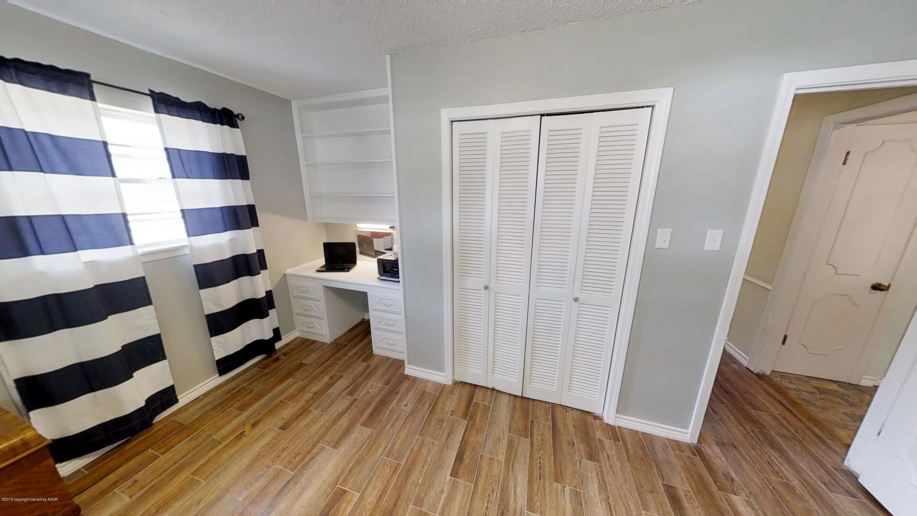 3308 Bedford Road Amarillo, TX 79106 - Photo 22 of 31 a view of a living room with wooden floor and a cabinet