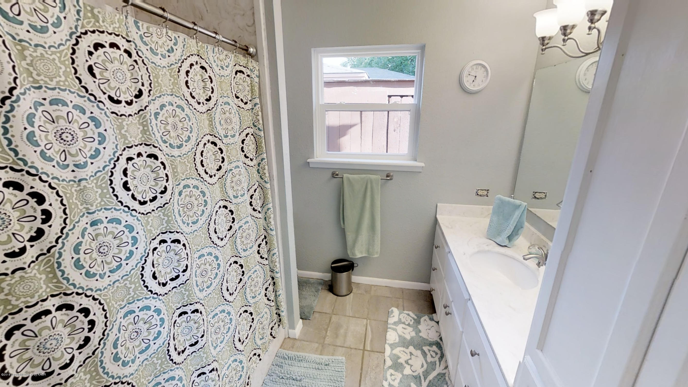 3308 Bedford Road Amarillo, TX 79106 - Photo 5 of 31 a bathroom with a toilet and a window