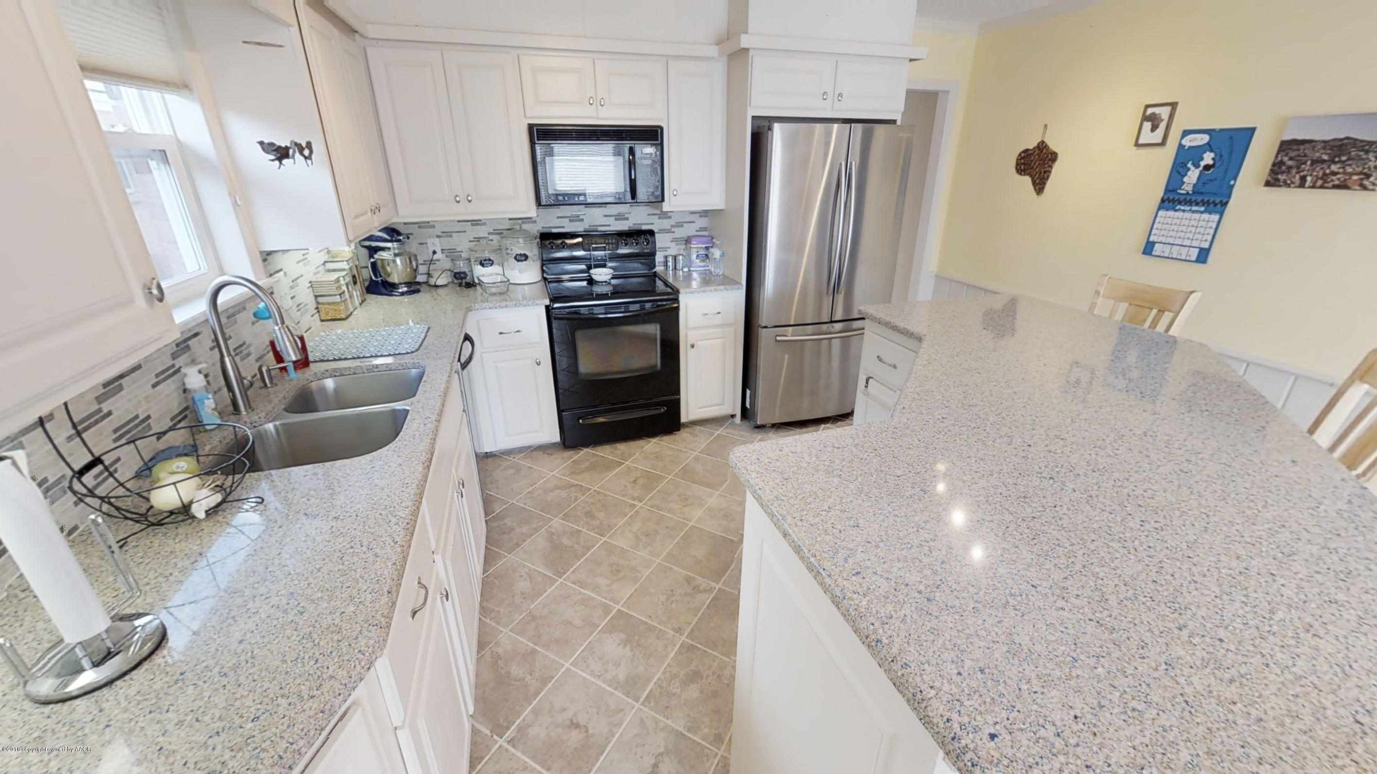 3308 Bedford Road Amarillo, TX 79106 - Photo 7 of 31 a kitchen with stainless steel appliances granite countertop a refrigerator a stove and a sink with wooden floor