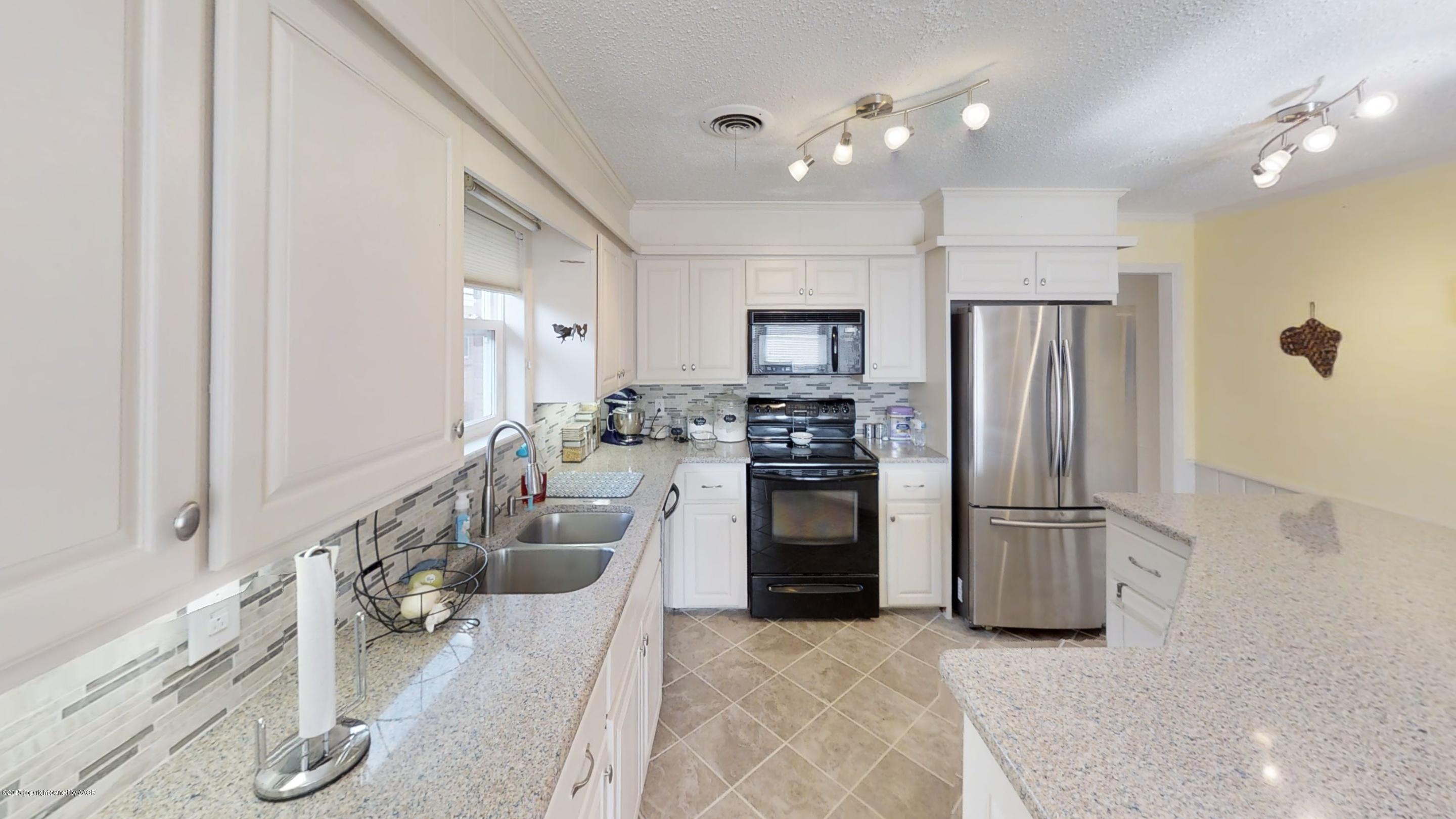 3308 Bedford Road Amarillo, TX 79106 - Photo 8 of 31 a kitchen with stainless steel appliances granite countertop a refrigerator and a sink