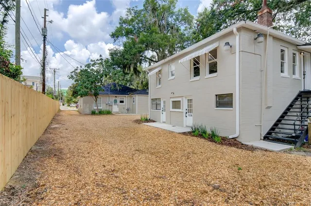 a view of a house with a backyard