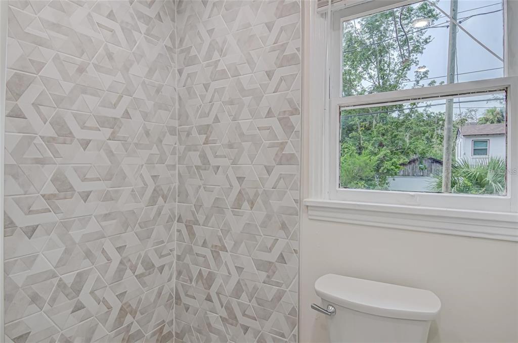 921 Southwest 6th Avenue, Unit B Gainesville, FL 32601 - Photo 13 of 18 a white toilet sitting next to a window