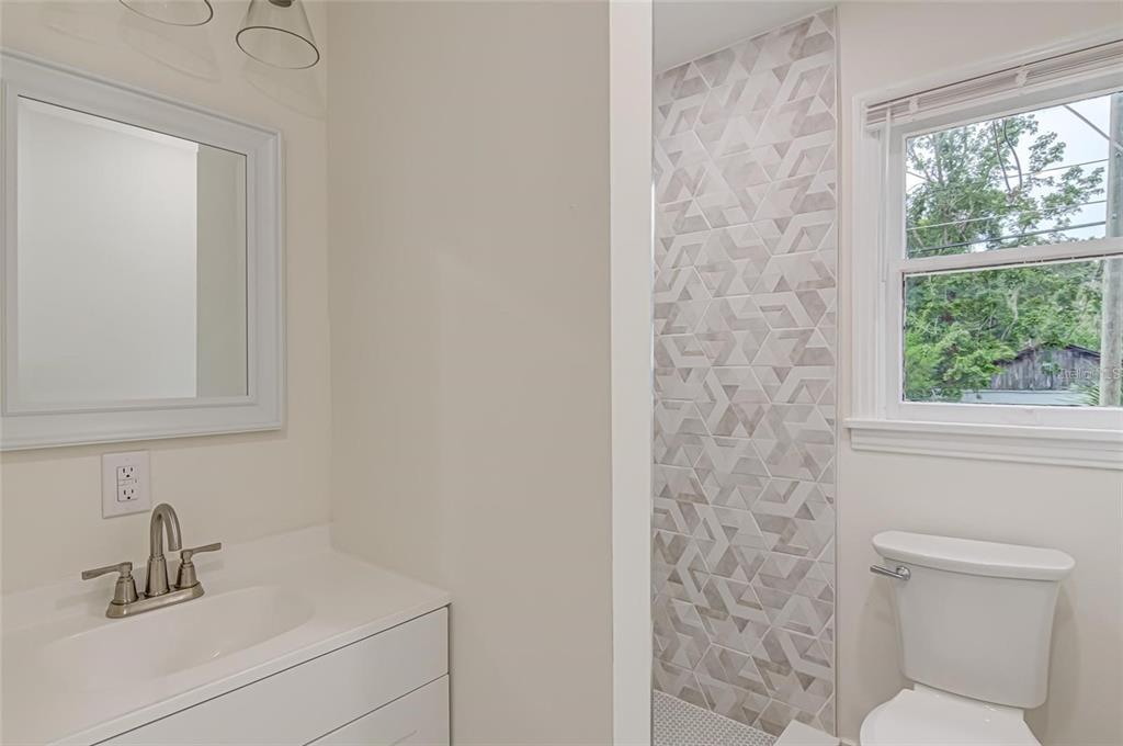 921 Southwest 6th Avenue, Unit B Gainesville, FL 32601 - Photo 14 of 18 a bathroom with a sink a toilet and a window