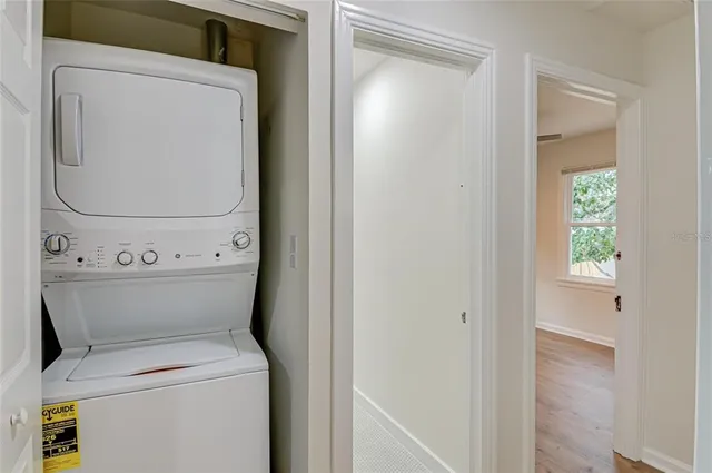 a kitchen with stainless steel appliances granite countertop a sink a window and wooden floor