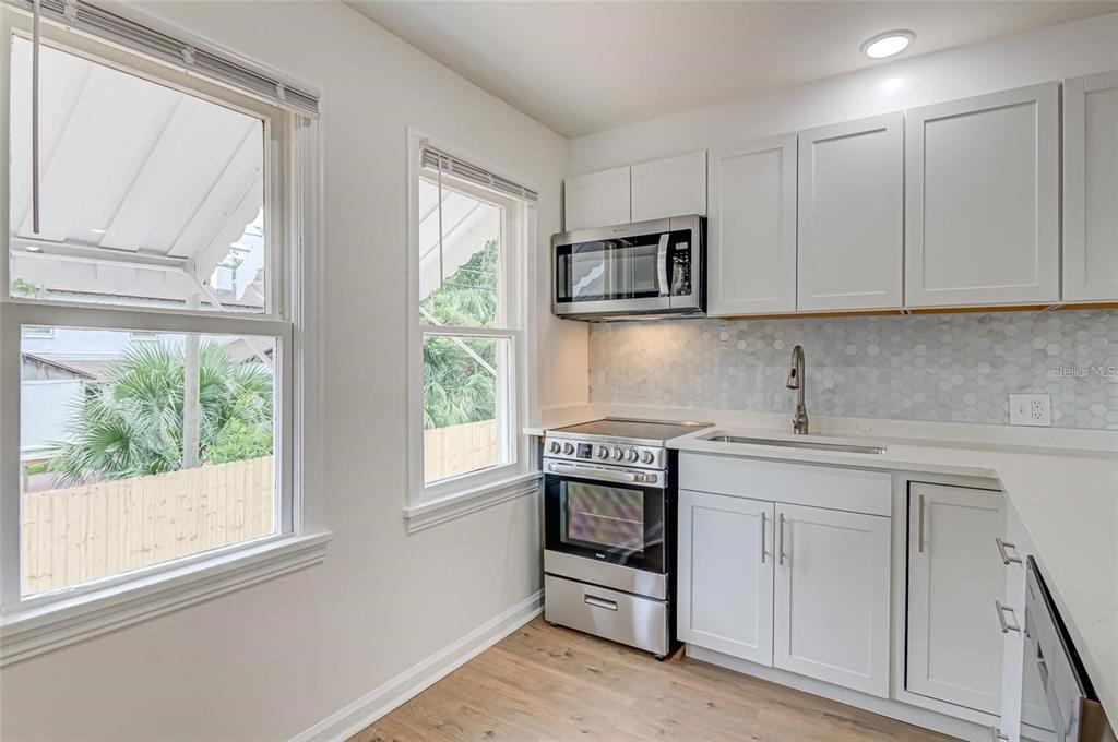921 Southwest 6th Avenue, Unit B Gainesville, FL 32601 - Photo 5 of 18 a kitchen with white cabinets and a window