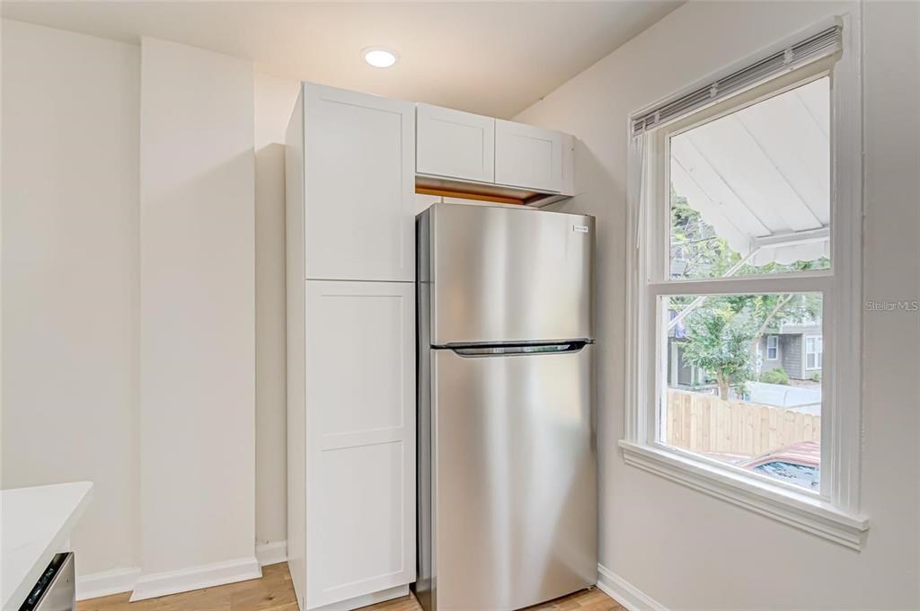 921 Southwest 6th Avenue, Unit B Gainesville, FL 32601 - Photo 7 of 18 a white refrigerator freezer and a window in a kitchen
