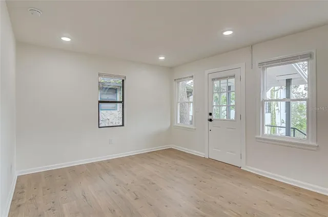 an empty room with windows and closet