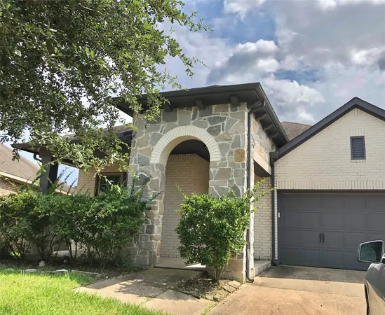 a front view of a house with plants