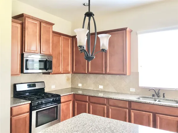 a kitchen with a sink a stove and a window