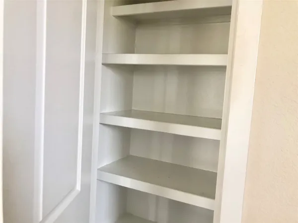 a kitchen with stainless steel appliances granite countertop a sink a stove top oven a refrigerator a sink and dishwasher with wooden floor