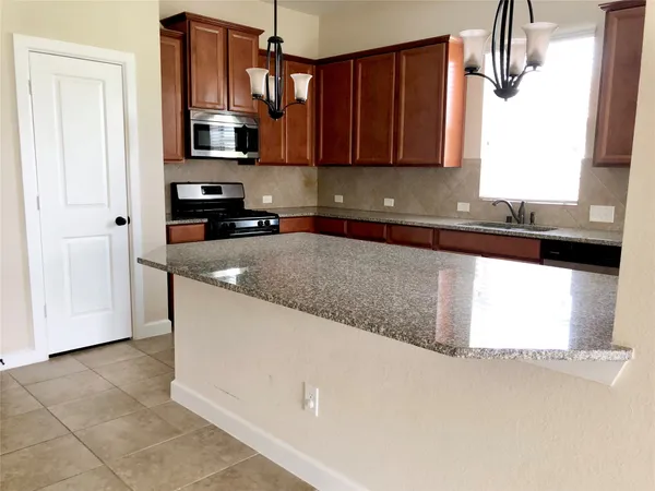 a view of a kitchen with furniture and windows