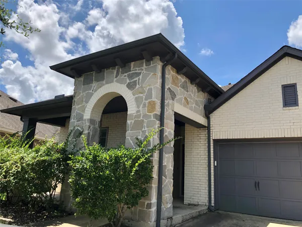 a front view of a house with plants