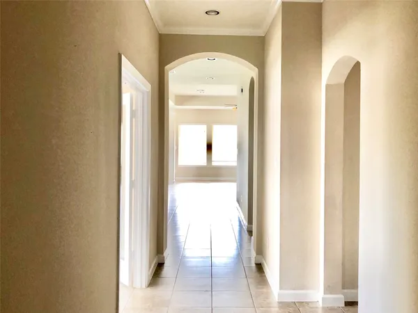 a view of a hallway with a dining room