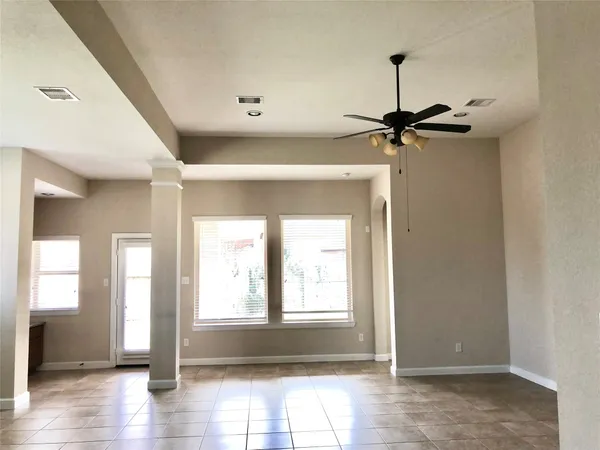 a view of a hallway with a window and wooden floor