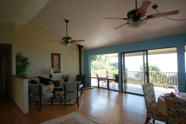 82-1204 Kinue Road Captain Cook, HI 96704 - Photo 5 of 17 a view of a livingroom with furniture wooden floor and windows