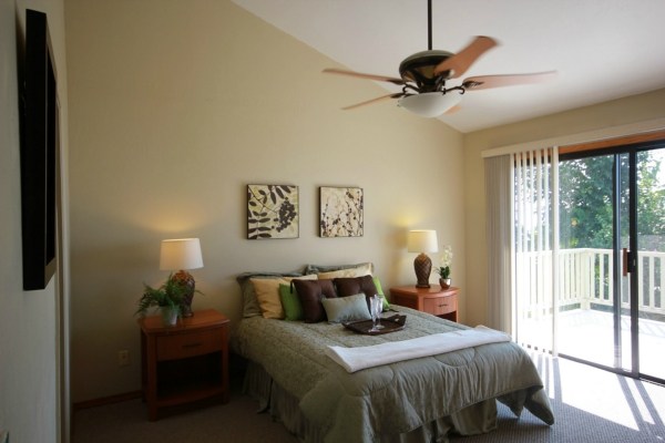 82-1204 Kinue Road Captain Cook, HI 96704 - Photo 10 of 17 a bedroom with a bed and a chandelier