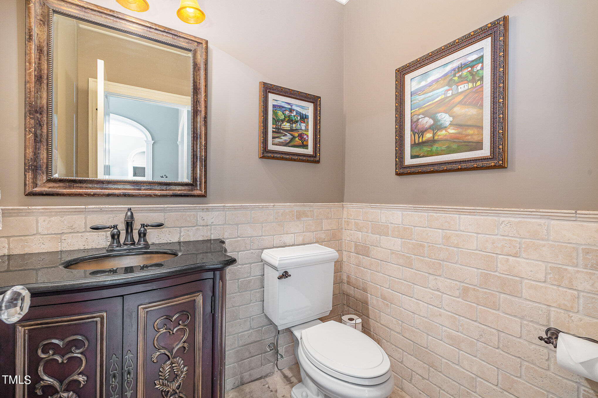 96 Barringer Drive Garner, NC 27529 - Photo 14 of 35 a bathroom with a toilet a sink and mirror