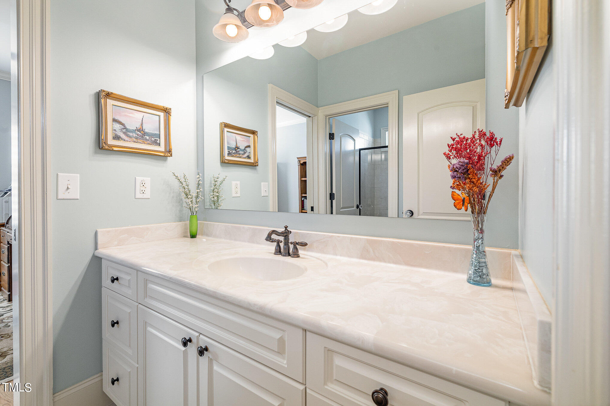 96 Barringer Drive Garner, NC 27529 - Photo 27 of 35 a bathroom with a sink and a mirror
