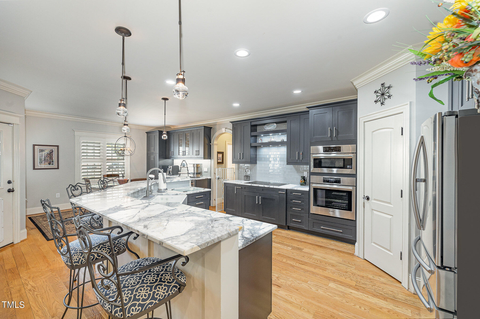 96 Barringer Drive Garner, NC 27529 - Photo 10 of 35 a kitchen with granite countertop a refrigerator a stove a sink a dining table and chairs with wooden floor