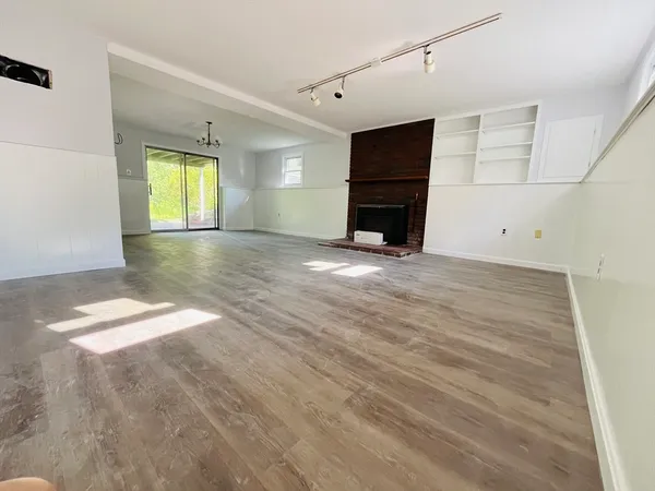 a view of empty room with a fireplace