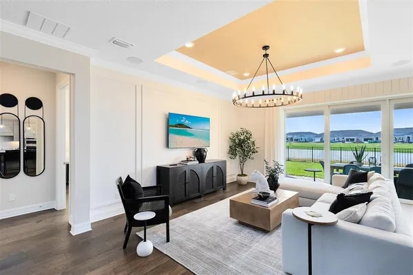 a living room with furniture and a chandelier