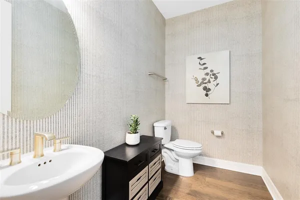 a bathroom with a sink toilet and a mirror
