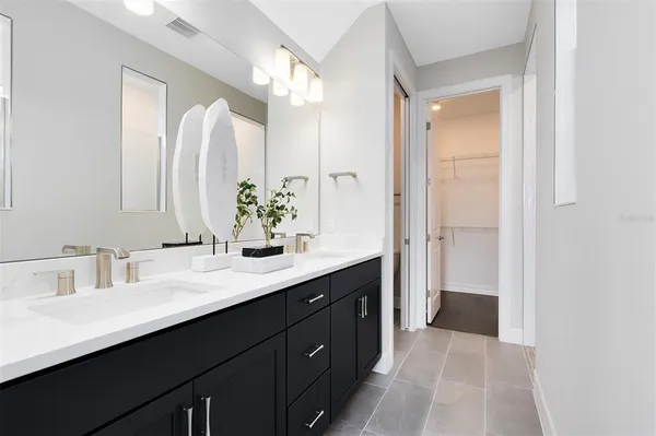 a bathroom with a double vanity sink mirror and double