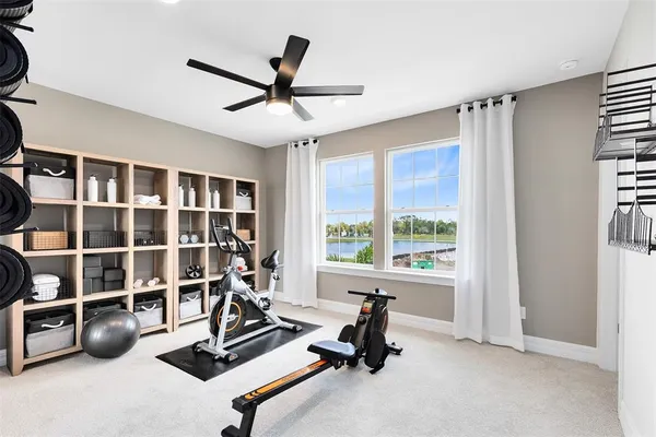 a view of a room with gym equipment and a large window