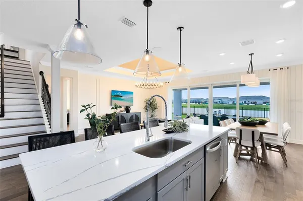 a very nice looking dining room with a large window and chandelier