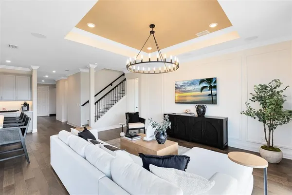 a living room with furniture and a chandelier