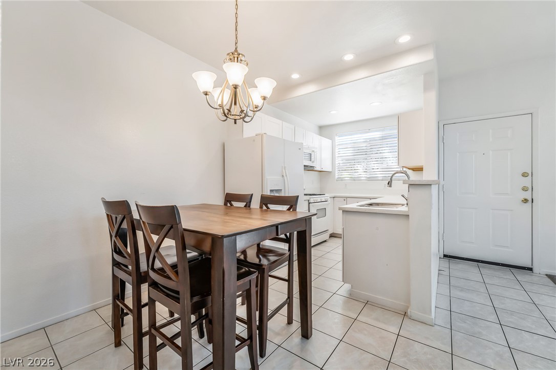 2201 Ramsgate Drive, Unit 811 Henderson, NV 89074 - Photo 9 of 36 Brightly lit open-concept kitchen and dining area with clean white finishes.