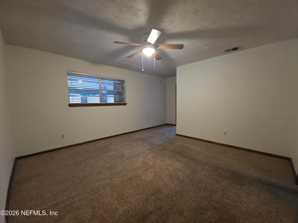 a view of an empty room with a window
