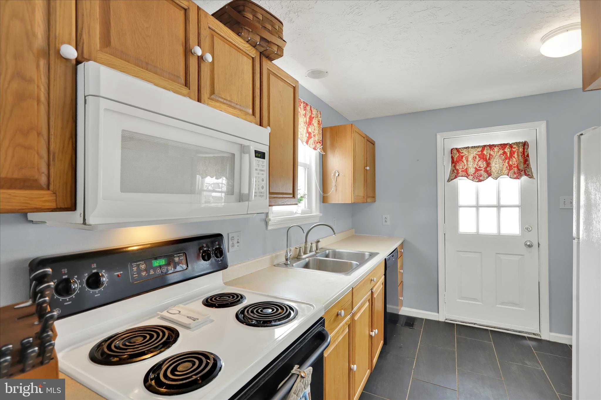 757 North Manor Road Elverson, PA 19520 - Photo 6 of 22 a kitchen with a stove and a microwave