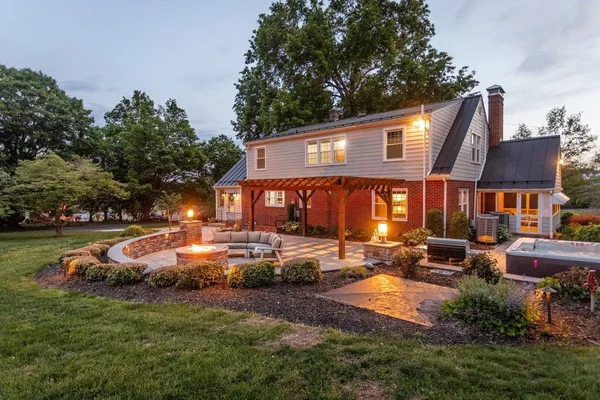 a front view of a house with garden and trees