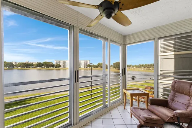 a kitchen with stainless steel appliances granite countertop a refrigerator a sink a stove and a wooden floors