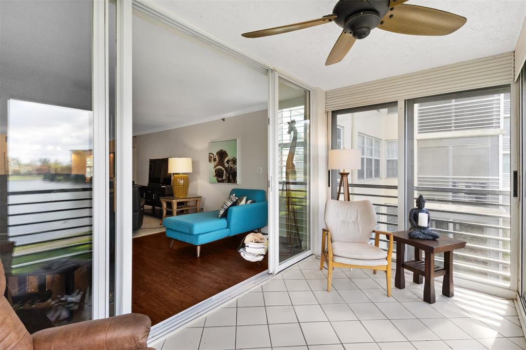 3095 North Course Drive, Unit 203 Pompano Beach, FL 33069 - Photo 12 of 49 a living room with furniture and a window