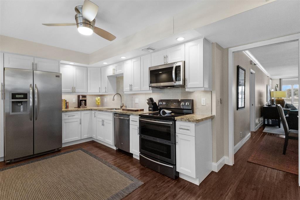 3095 North Course Drive, Unit 203 Pompano Beach, FL 33069 - Photo 14 of 49 a kitchen with a refrigerator stove and microwave